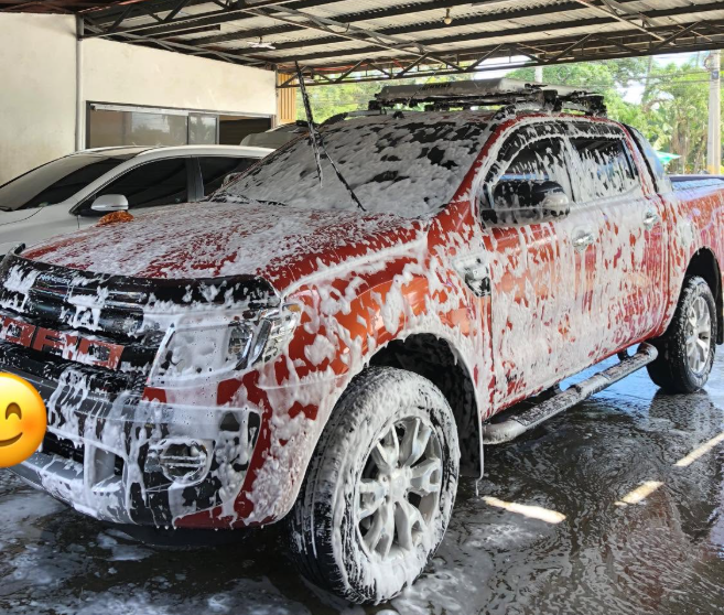 Pickup truck covered in foam at El Primo Carwash